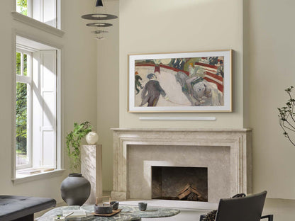 Living room with a fireplace and framed artwork on the wall